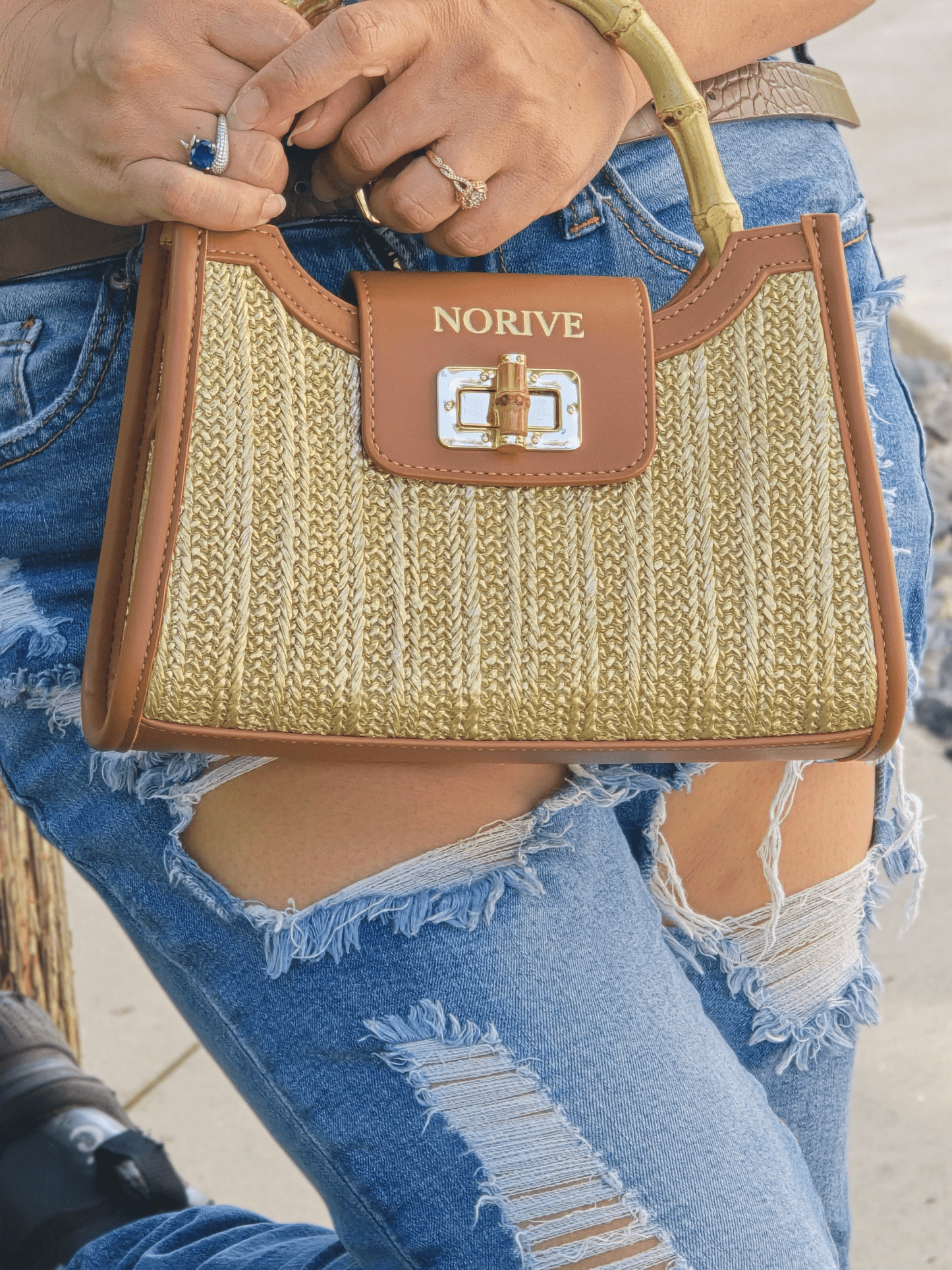 woman holding NORIVE Isla Bamboo Satchel woven straw handbag