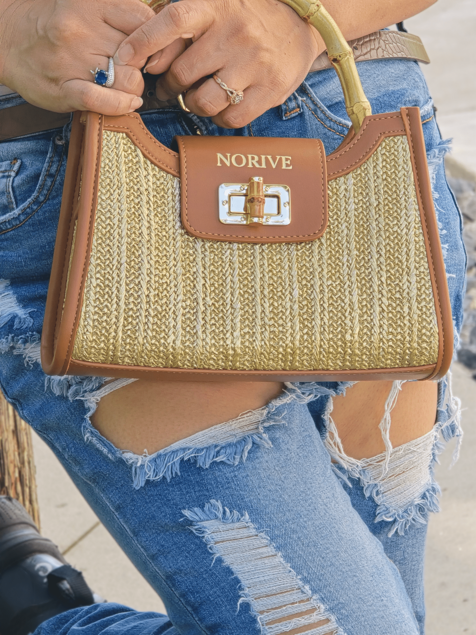 woman holding NORIVE Isla Bamboo Satchel woven straw handbag
