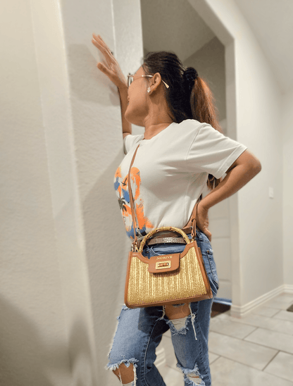 woman carrying NORIVE Isla Bamboo Satchel woven straw handbag